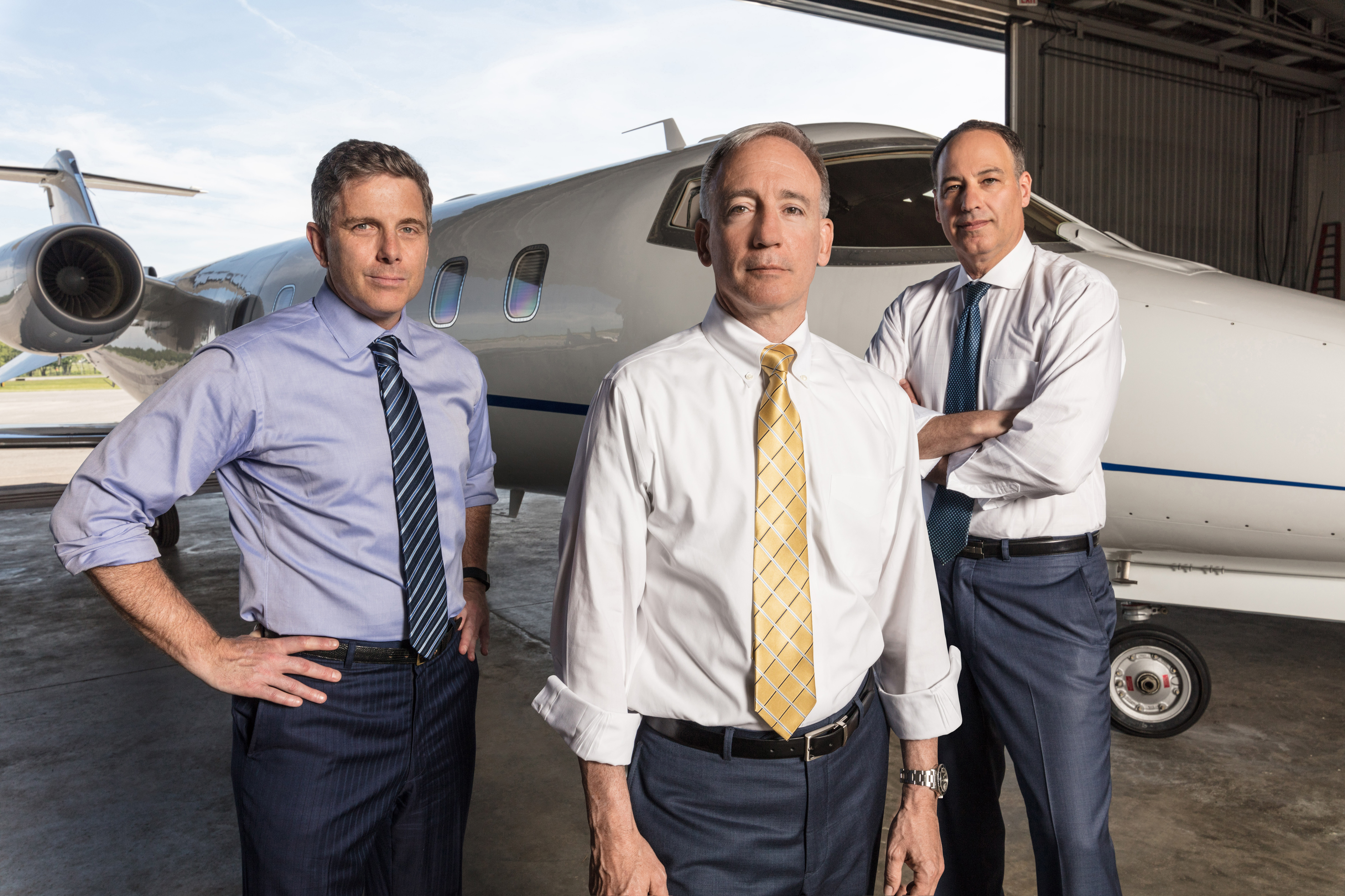 Kreindler partners Justin Green, Brian Alexander, and Dan Rose by an aircraft
